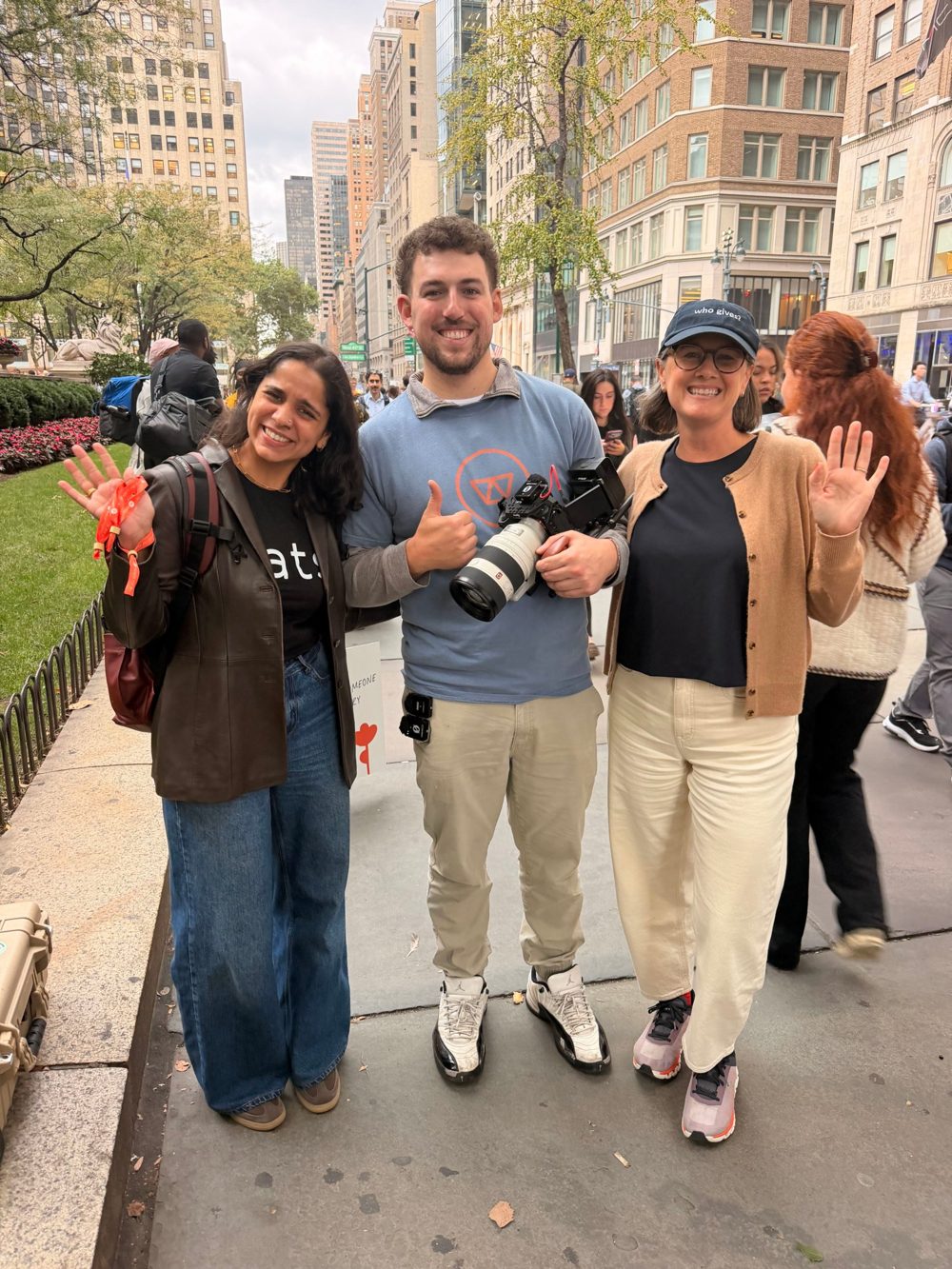 A Happy Productions producer on set in New York with two partners, holding a cinema camera